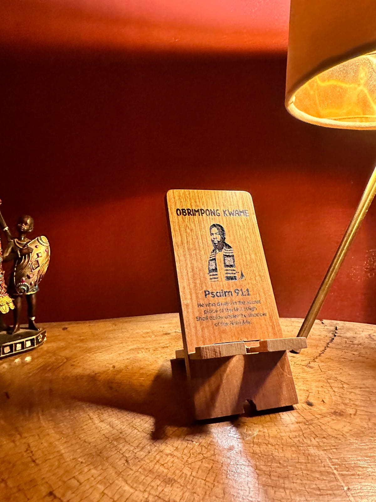 Portrait-style engraving on a Mahogana phone stand